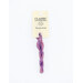 A skein of variegated pink and purple embroidery floss, twisted and bundled, with a cream and black label featuring the brand name and color information.