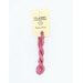A skein of pink embroidery floss, twisted and bundled, with a cream and black label featuring the brand name and color information.
