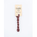 A skein of mauve brown embroidery floss, twisted and bundled, with a cream and black label featuring the brand name and color information.