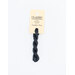 A skein of soft black embroidery floss, twisted and bundled, with a cream and black label featuring the brand name and color information.