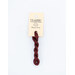 A skein of red embroidery floss, twisted and bundled, with a cream and black label featuring the brand name and color information.