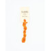 A skein of orange embroidery floss, twisted and bundled, with a cream and black label featuring the brand name and color information.