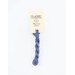 A skein of cornflower blue embroidery floss, twisted and bundled, with a cream and black label featuring the brand name and color information.