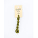 A skein of green embroidery floss, twisted and bundled, with a cream and black label featuring the brand name and color information.