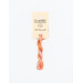 A skein of variegated peach, and pink embroidery floss, twisted and bundled, with a cream and black label featuring the brand name and color information.