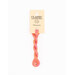 A skein of variegated orange and pink embroidery floss, twisted and bundled, with a cream and black label featuring the brand name and color information.