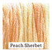 A variegated swatch of Classic Colorworks floss in the colors peach and yellow. 