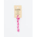 A skein of bright pink embroidery floss, twisted and bundled, with a cream and black label featuring the brand name and color information.
