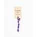 A skein of light plum embroidery floss, twisted and bundled, with a cream and black label featuring the brand name and color information.