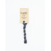 A skein of dark gray embroidery floss, twisted and bundled, with a cream and black label featuring the brand name and color information.