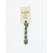 A skein of green embroidery floss, twisted and bundled, with a cream and black label featuring the brand name and color information.