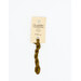 A skein of suede brown embroidery floss, twisted and bundled, with a cream and black label featuring the brand name and color information.