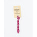 A skein of bright pink embroidery floss, twisted and bundled, with a cream and black label featuring the brand name and color information.