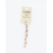 A skein of variegated cream and pastel purple embroidery floss, twisted and bundled, with a cream and black label featuring the brand name and color information.