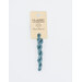 A skein of powder blue embroidery floss, twisted and bundled, with a cream and black label featuring the brand name and color information.