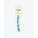 A skein of teal embroidery floss, twisted and bundled, with a cream and black label featuring the brand name and color information.