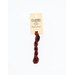 A skein of red embroidery floss, twisted and bundled, with a cream and black label featuring the brand name and color information.