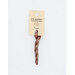 A skein of variegated terra cotta and tan embroidery floss, twisted and bundled, with a cream and black label featuring the brand name and color information.
