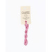 A skein of pink embroidery floss, twisted and bundled, with a cream and black label featuring the brand name and color information.
