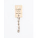 A skein of gray cream embroidery floss, twisted and bundled, with a cream and black label featuring the brand name and color information.
