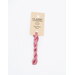 A skein of rose pink embroidery floss, twisted and bundled, with a cream and black label featuring the brand name and color information.