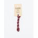 A skein of mauve embroidery floss, twisted and bundled, with a cream and black label featuring the brand name and color information.