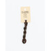 A skein of variegated brown and green embroidery floss, twisted and bundled, with a cream and black label featuring the brand name and color information.
