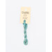 A skein of light blue embroidery floss, twisted and bundled, with a cream and black label featuring the brand name and color information.