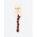 A skein of brick red embroidery floss, twisted and bundled, with a cream and black label featuring the brand name and color information.