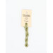 A skein of pastel green embroidery floss, twisted and bundled, with a cream and black label featuring the brand name and color information.