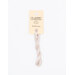A skein of linen embroidery floss, twisted and bundled, with a cream and black label featuring the brand name and color information.