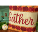 A close up on the pillow showing color and pattern details on the appliqué letter fabrics and scalloped border.