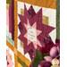 An angled close up on one of the patchwork star blocks with a panel square nestled in the center, reading "Be strong and let your heart take courage. Psalm 31:24."