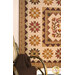 A closer look at the Heartland quilt, showcasing color and print details on the patchwork blocks and border fabrics.