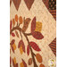 A stylized super close up on the appliqué floral emblem, taken at a slight angle and showcasing fabric print details.