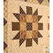 An angled close up on one of the patchwork blocks, showing fabric details on the nine-patch and half square triangles.