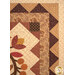 A close up on the triangle borders that frame the floral medallion, demonstrating fabric color and print details as well as top quilting effects.