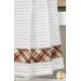 A close up on the plaid brown and green fabric on the bottom stripe of the towel.