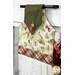 An angled shot of the top fabrics of the towel, showing details on the cream and green leaf prints.