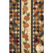 A close up on a row of pumpkin appliqué between two rows of on-point square patchwork, demonstrating fabric colors and details as well as top stitching effects.