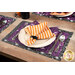 A table setting made with the Witchy Woods placemat and cloth napkin, staged with silver cutlery.
