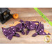 A top down shot of the completed napkins colored in purple and orange Halloween-themed fabrics from the Witchy Woods collection, staged on a wooden table with coordinating seasonal decor.