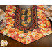 A close up on one end of the runner, showing details on the vibrant autumn themed fabrics.