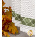 A super close up on the green plaid fabric stripe at the bottom of the towel.