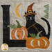 A close up on the other L block, featuring a black cat wearing a witch hat amongst large pumpkins.