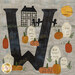 A close up on the W block, featuring pumpkins scattered amongst tombstones in a graveyard.