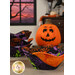 The completed Bowl Cozies colored in black, green, purple, and orange fabrics from the Tonga Haunted Batiks collection, staged on a wooden table with coordinating Halloween decor.