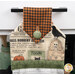 A head on shot of the top of the towel, demonstrating details on the newspaper and Halloween fabrics and the green fabric button.
