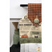A head on shot of the top of the towel, demonstrating details on the newspaper and Halloween fabrics and the green fabric button.