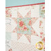 A super close up on the patchwork of the quilt, demonstrating print colors and detail as well as top stitching effects.